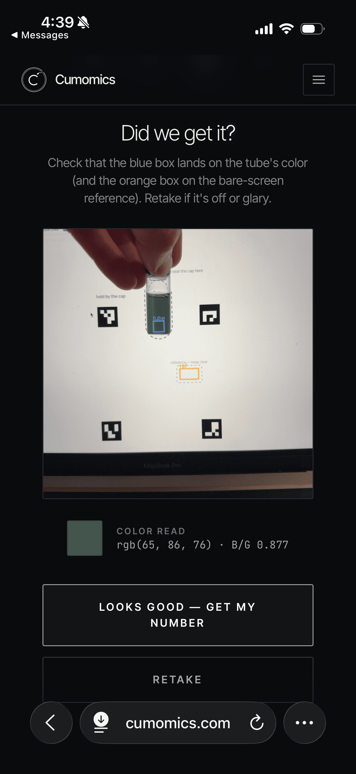 Cumomics scan step: aligning the tube against the lit screen for a color read.